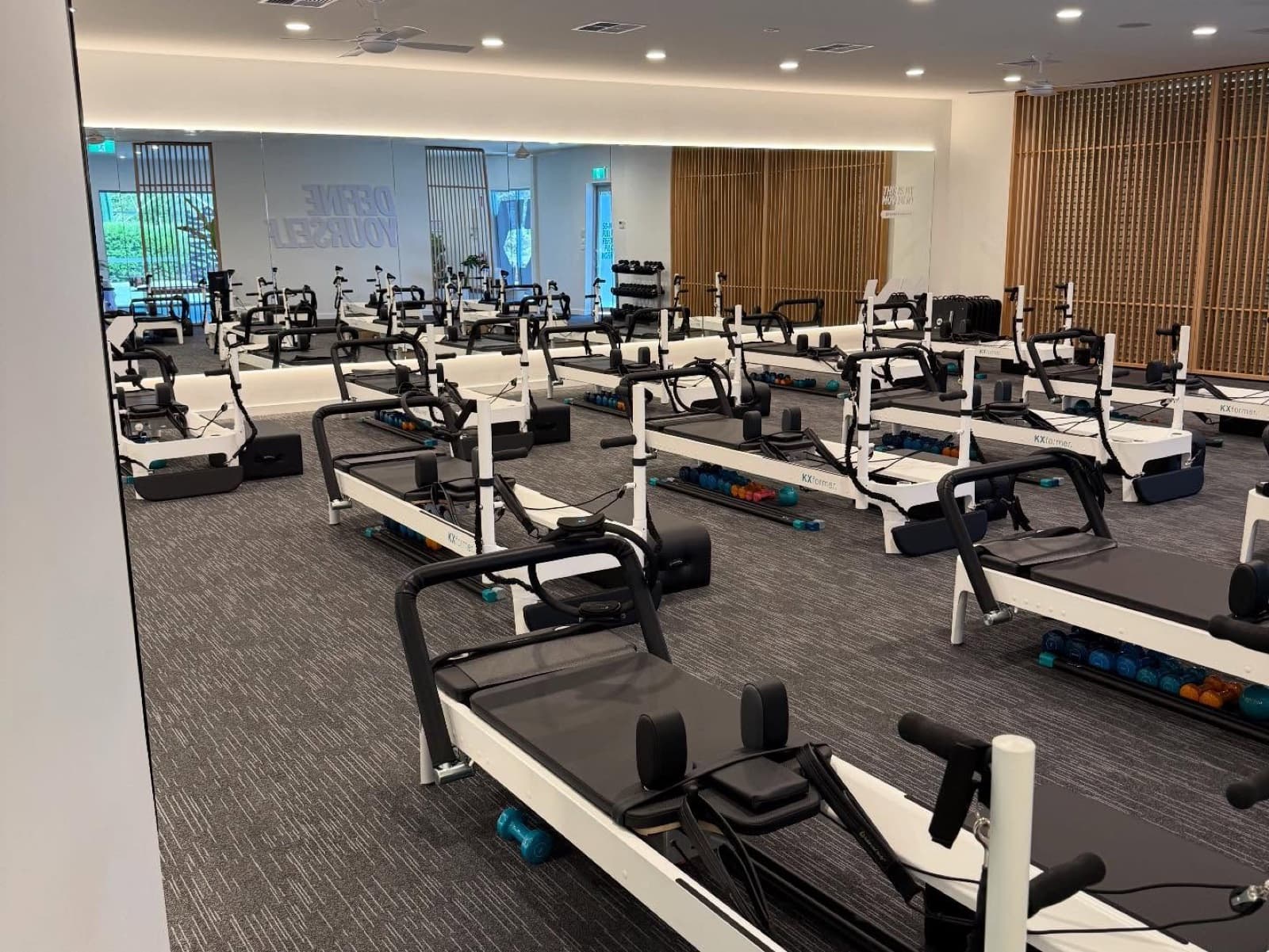 Interior fit-out of a Perth Pilates studio with painted walls and timber slat feature panelling